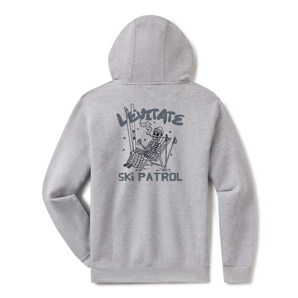 Levitate Ski Patrol Hoodie, back: Skeleton relaxing in a lawn chair with skis in the snow under orange Levitate Ski Patrol lettering