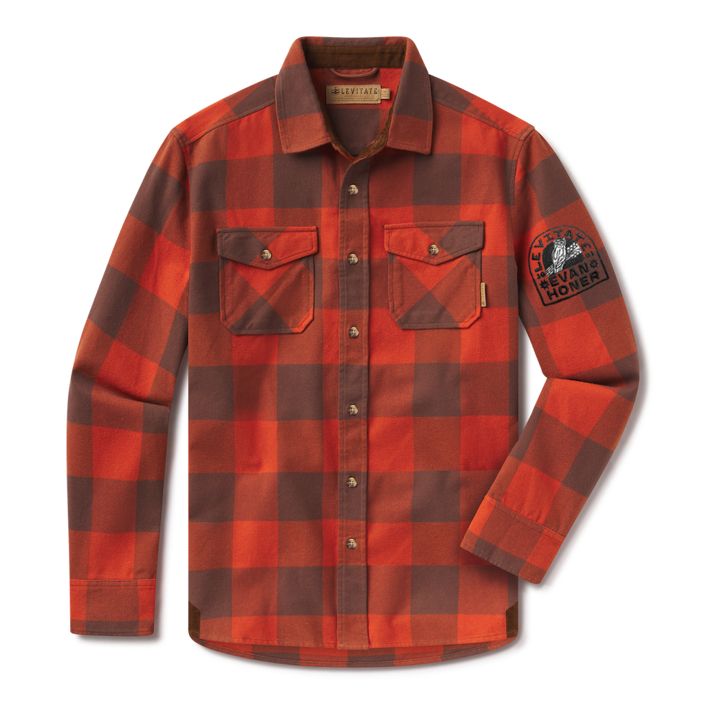 Levitate x Evan Honer Original Flannel, front: orange and brown buffalo check flannel with two flap chest pockets and a black embroidered patch on the left sleeve reading Levitate and Evan Honer around an owl on a guitar neck
