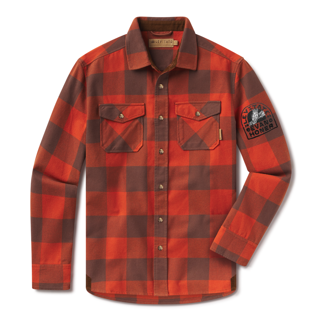 Levitate x Evan Honer Original Flannel, front: orange and brown buffalo check flannel with two flap chest pockets and a black embroidered patch on the left sleeve reading Levitate and Evan Honer around an owl on a guitar neck