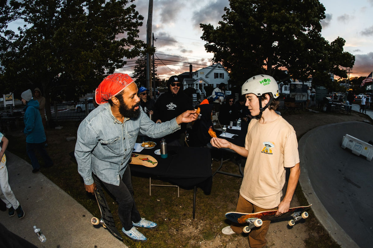 Food being passed around the crowd at the Shark Belly Classic as the sun goes down