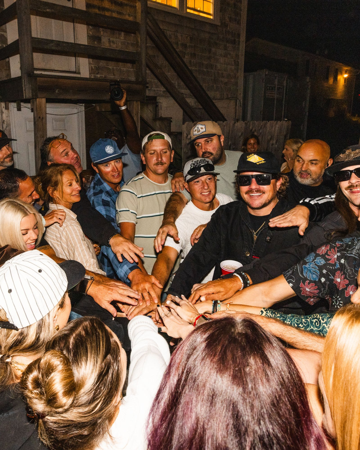 The Elovaters huddled with fans in the Levitate Backyard crowd, everyone's hands in the middle