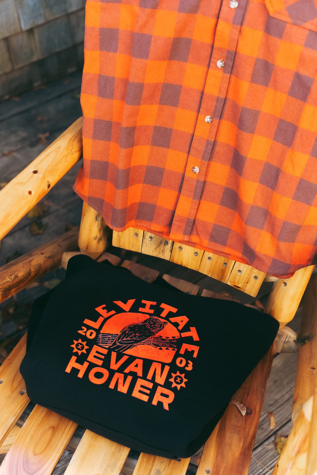 Levitate x Evan Honer Original Flannel hanging over the collab hoodie on a wooden chair