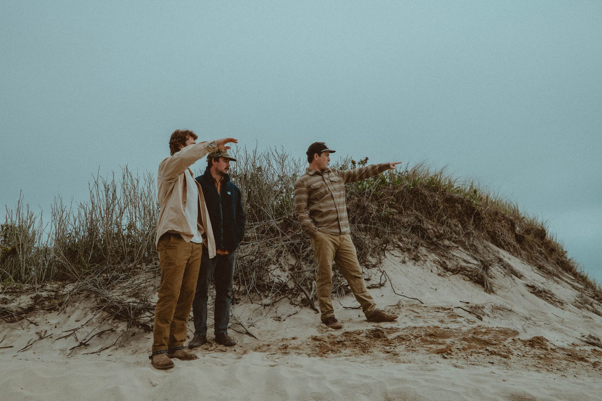 Evan Honer and a friend checking the surf from a dune behind Cisco on Nantucket