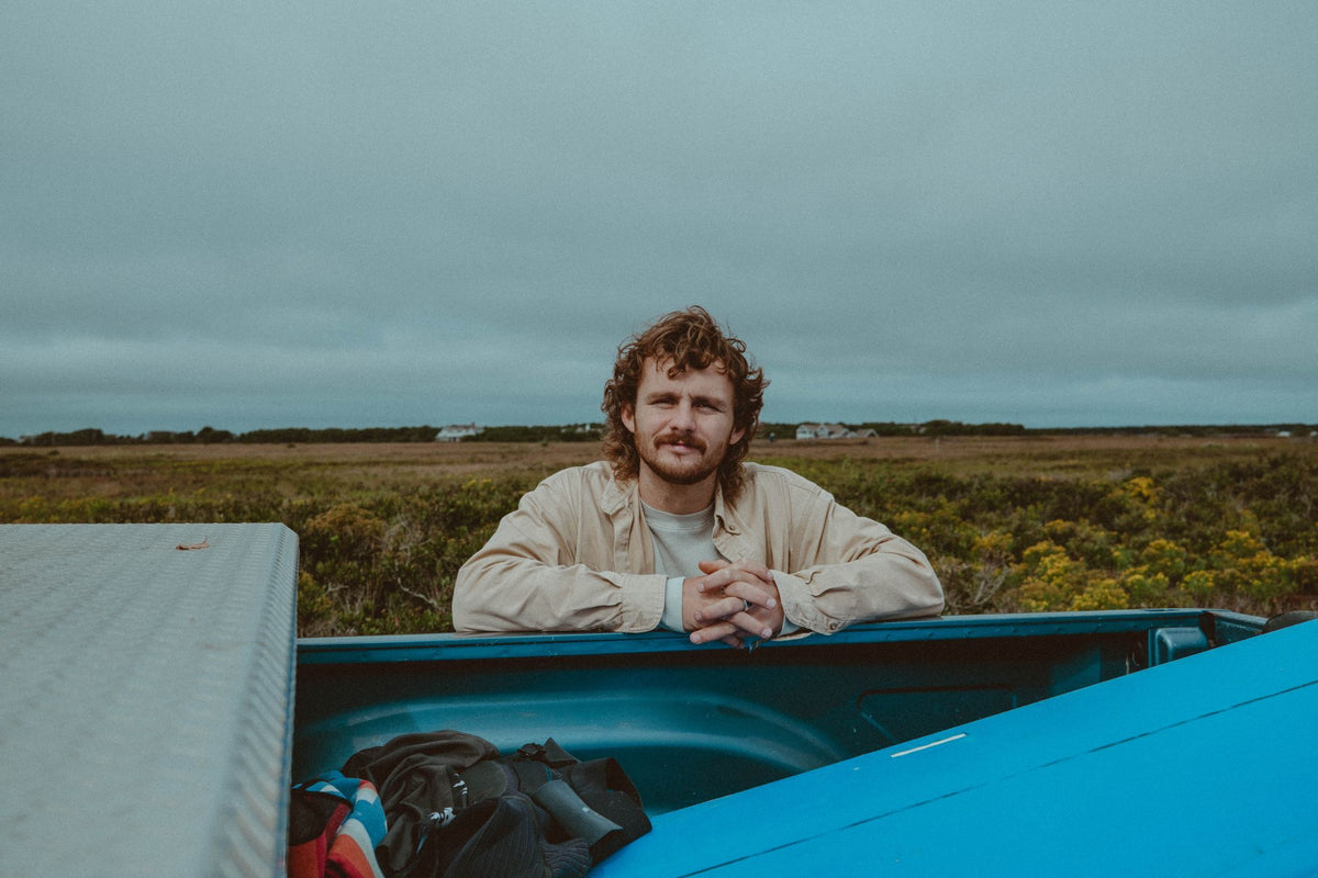 Evan Honer smiling from the back of a truck before the surf session on Nantucket