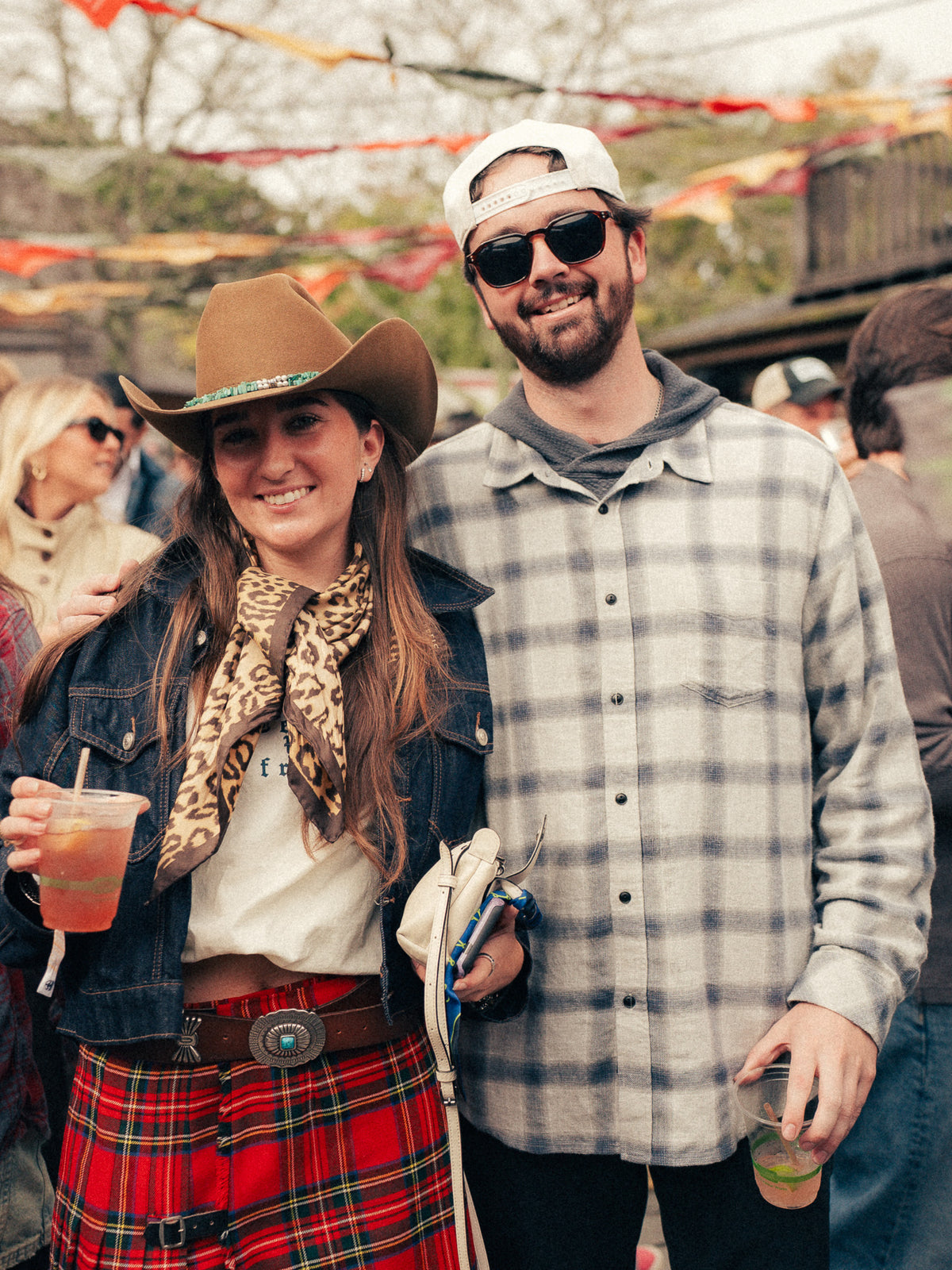 Two friends in flannel and cowboy hats at Flannel Jam Nantucket