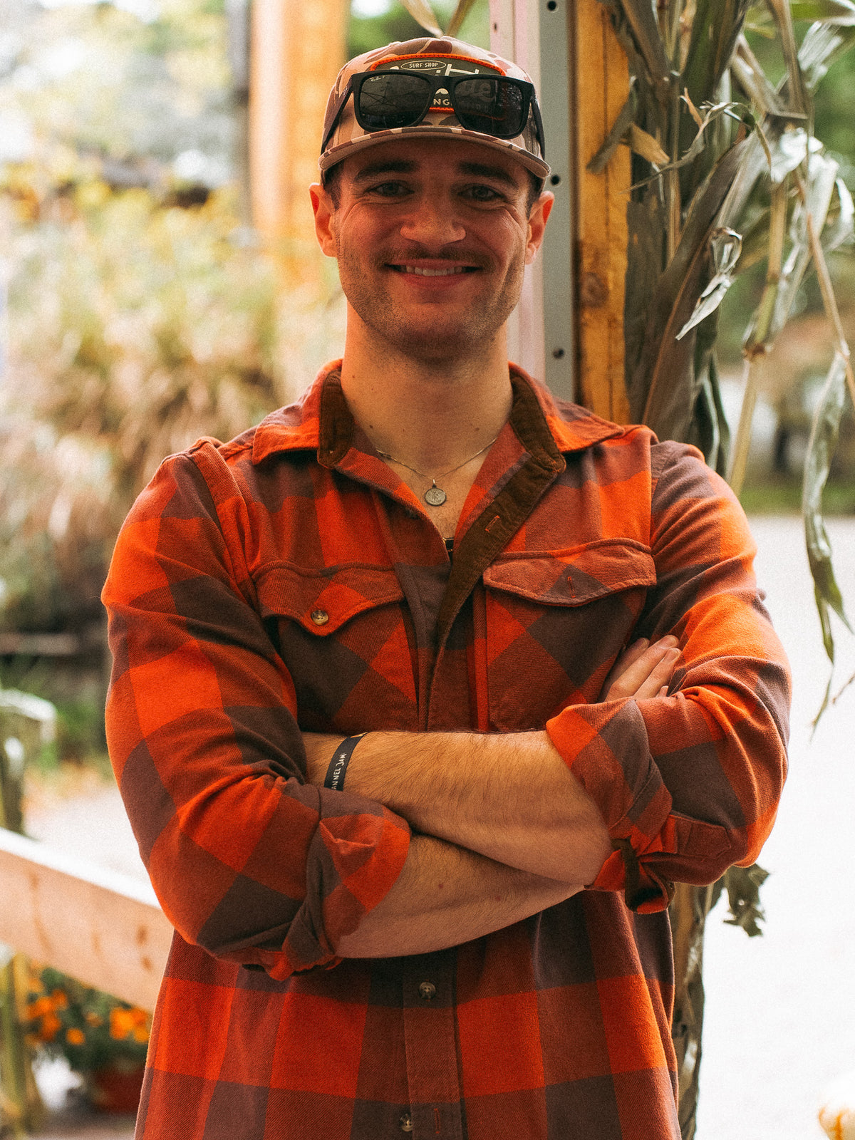 Man in a red plaid flannel with arms crossed at Cisco Brewers