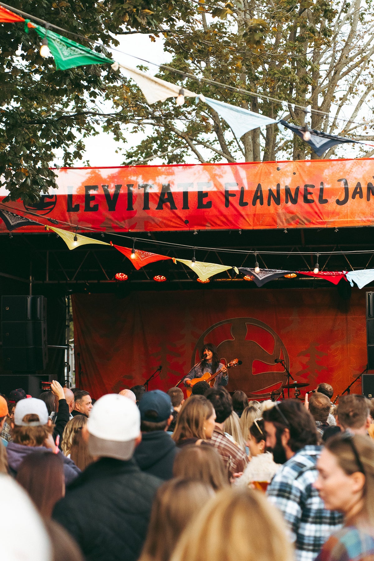 Crowd packed in front of the Levitate Flannel Jam stage in the Levitate Backyard on a fall afternoon in Marshfield