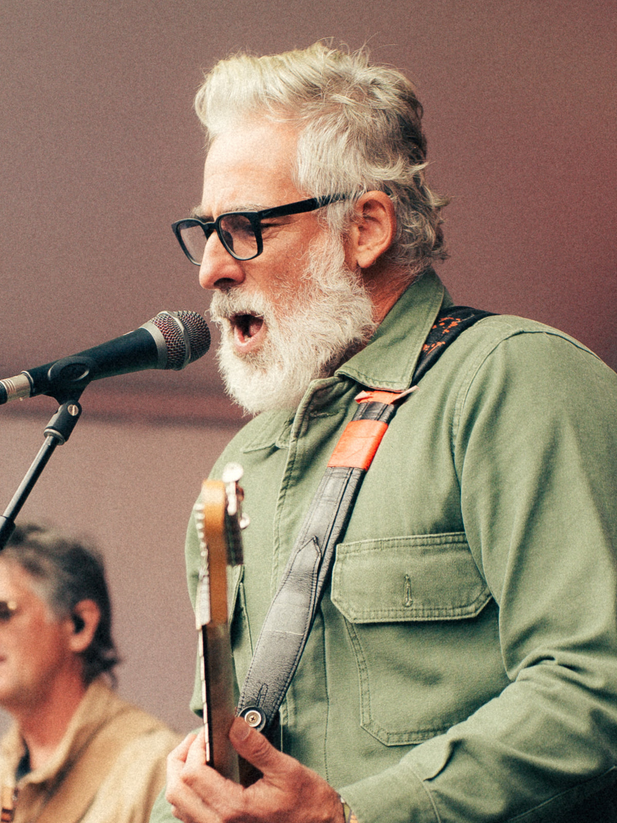 Doug of Doug & Co. singing and playing guitar on the Flannel Jam stage at Cisco Brewers